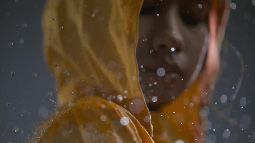 Rain pours over the woman