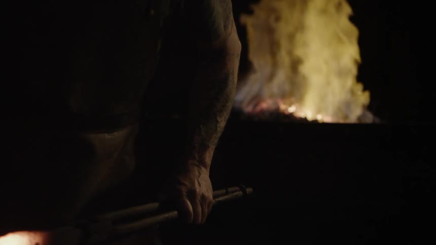 The man is working in the blacksmith