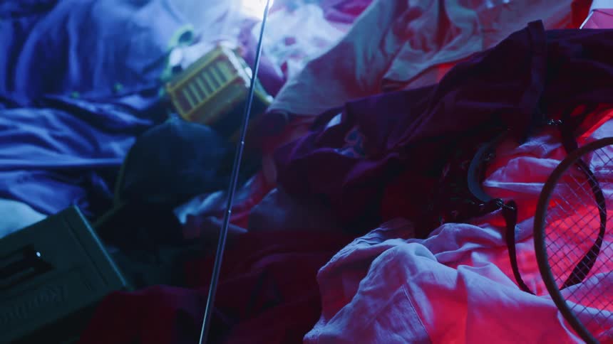 Man Playing On Pile Of Clothes In Studio