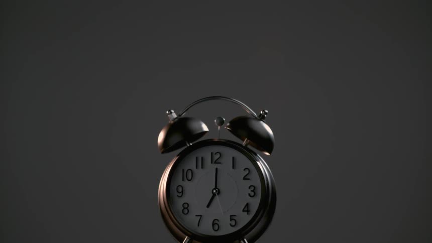 An alarm clock rings