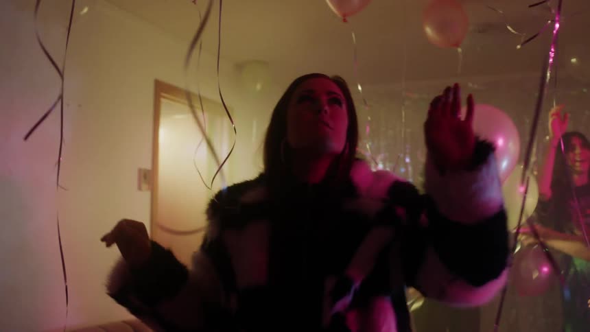 The people are partying with balloons everywhere