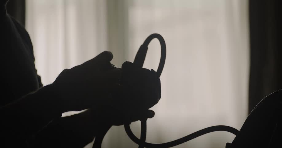 A person is attaching wires to a device