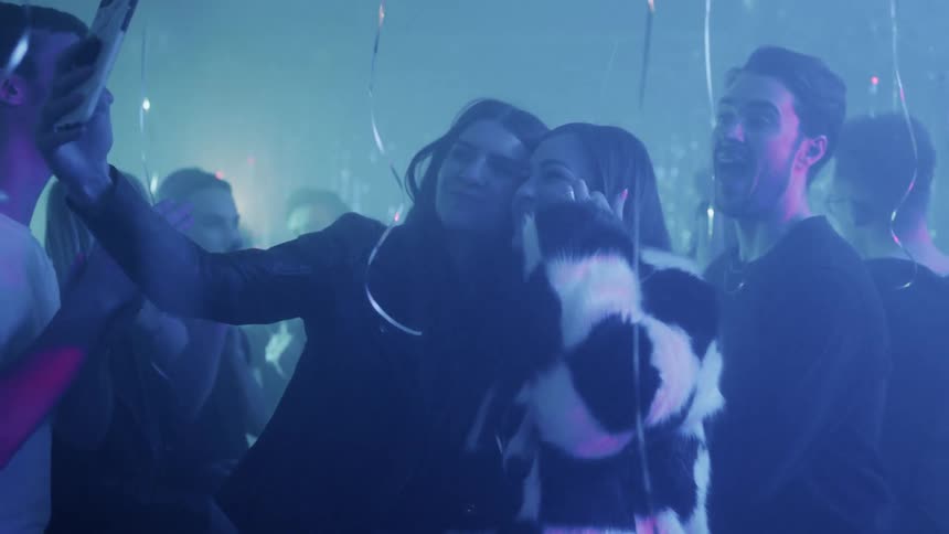 People pose for pictures at a party
