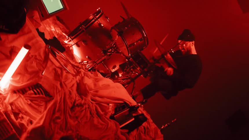 The red lights flash around the drummer