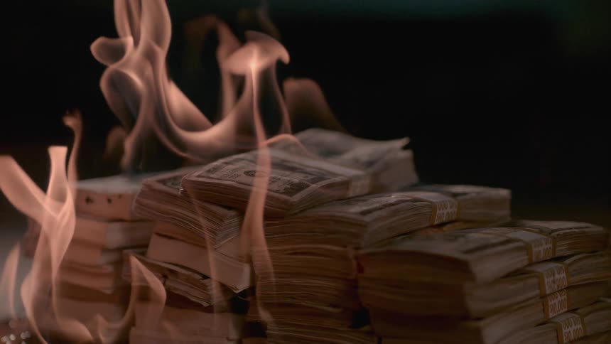 Bundles of banded bills are on fire