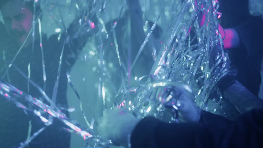 The people party and throw silver strands everywhere