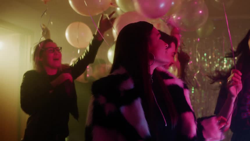 A group of people are partying in the dark room