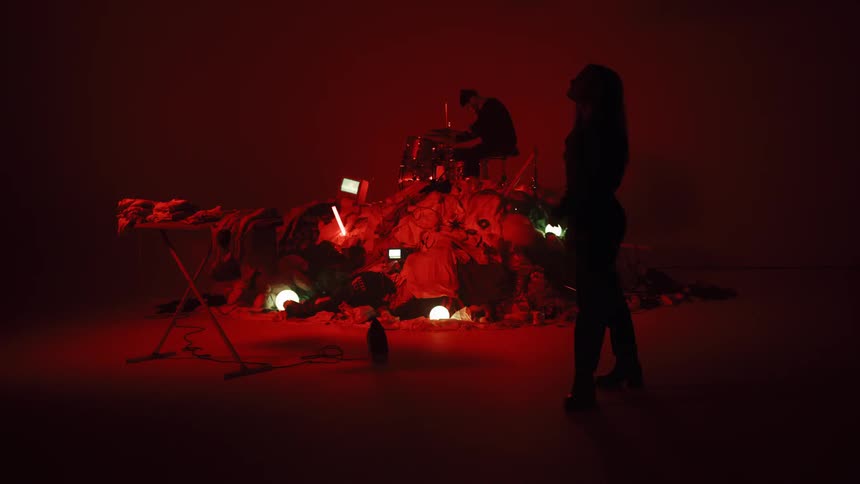 Man Playing On Pile Of Clothes In Studio