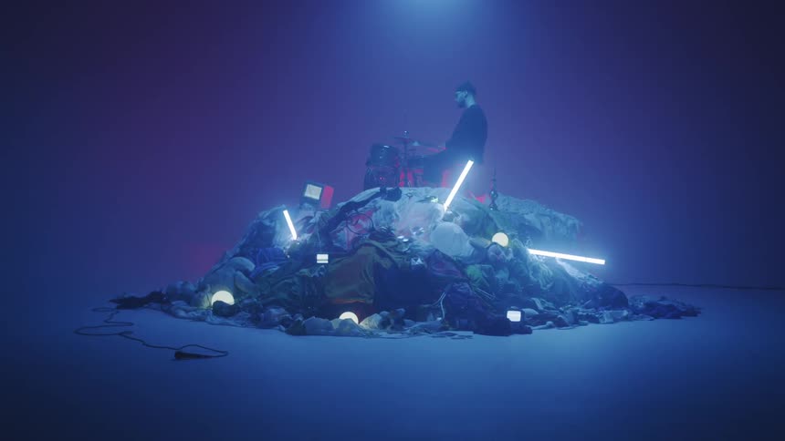 Man Playing On Pile Of Clothes In Studio