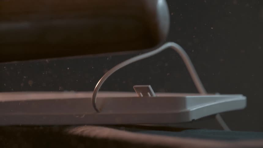 A baseball bat smashes a keyboard
