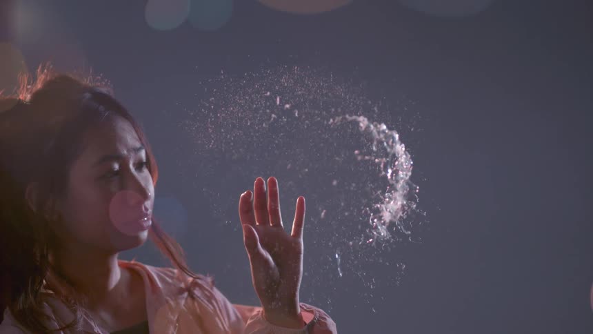 The woman pops a large bubble