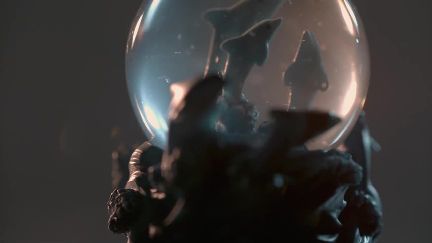 A snowglobe spins on a turn table