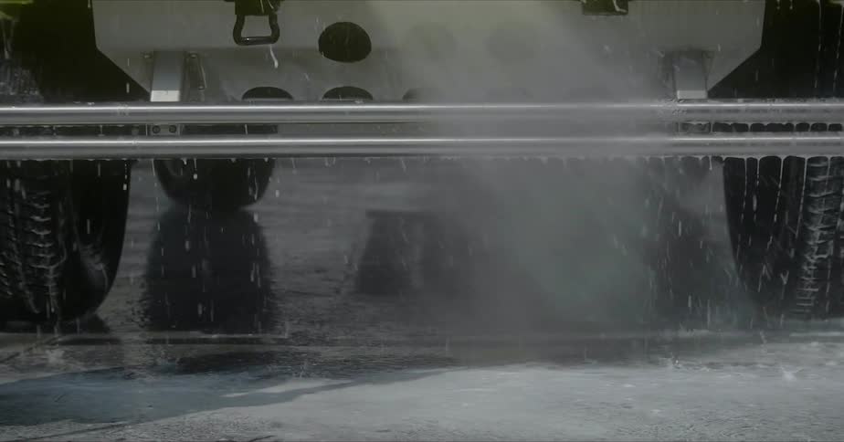 The vehicle is being sprayed with a hose