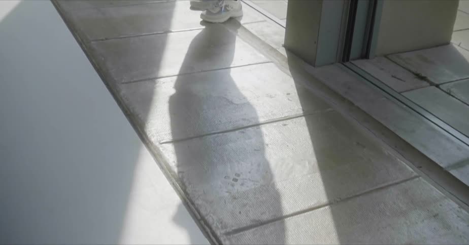 The person walks out on the concrete