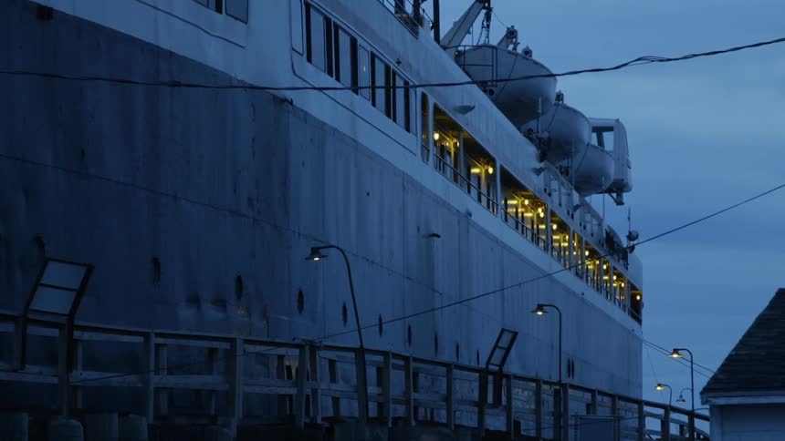 The large ship is docked at dawn