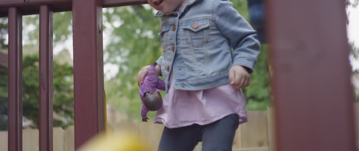 A young girl plays on a playground set
