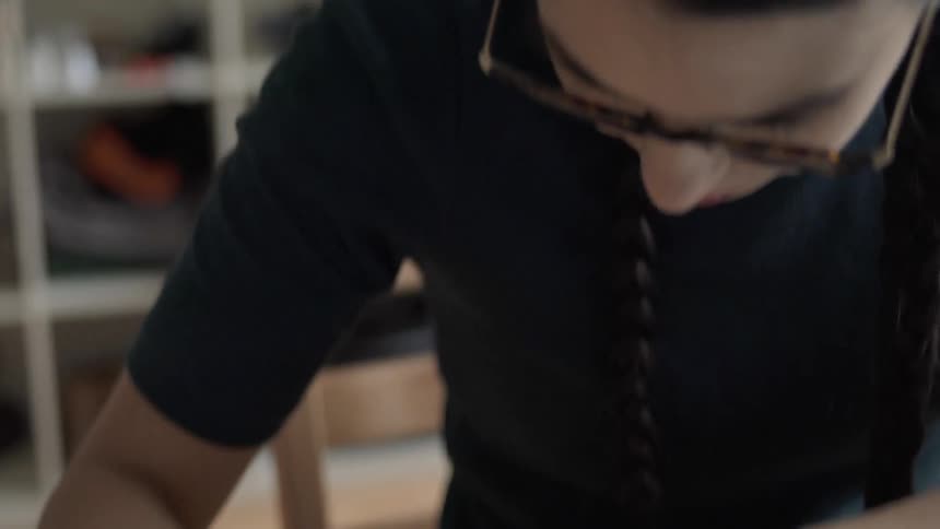 Woman writes on a small notepad