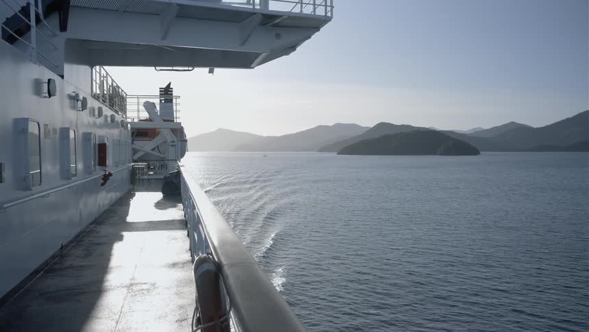 A ship floats on a large body of water