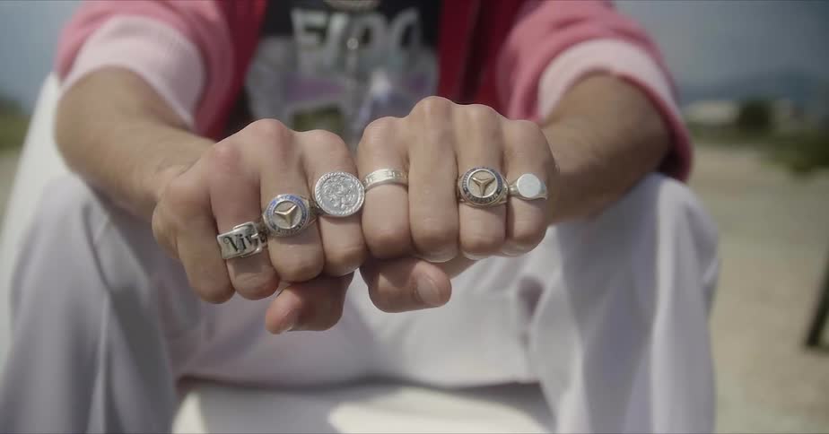 A person has his fists up showing off rings