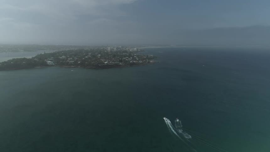 The boat is sailing towards the island