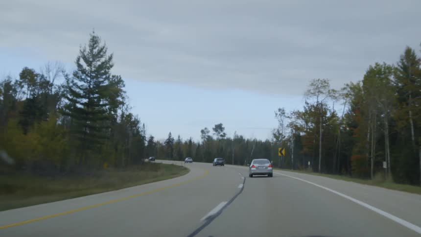 Vehicles travel on a rural road