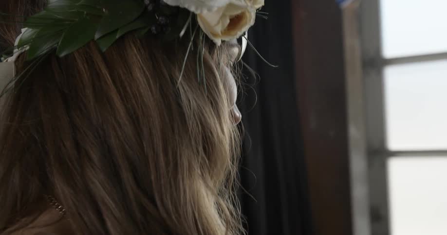 A woman wears a flower wreath on her head