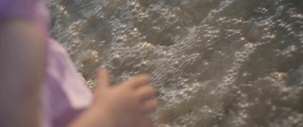 Girl Playing At The Beach