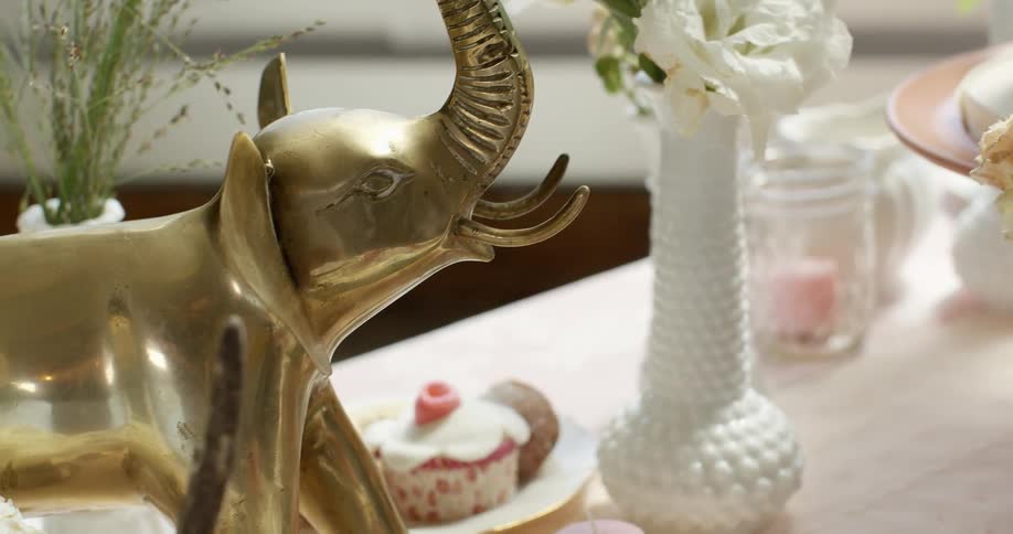 Golden elephant figurine on a table with other items