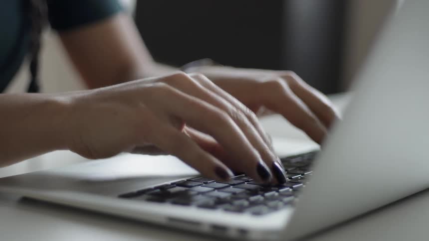 The person is typing on the keyboard
