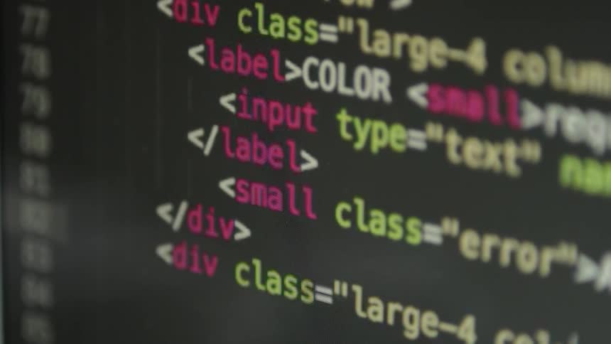 Colored text appears on the dark monitor