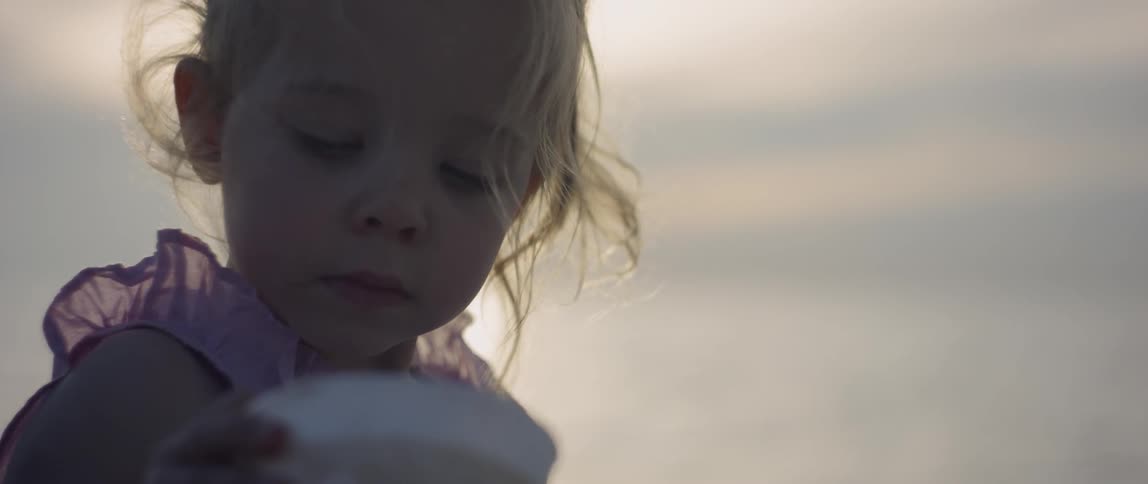 A young girl plays at the beach