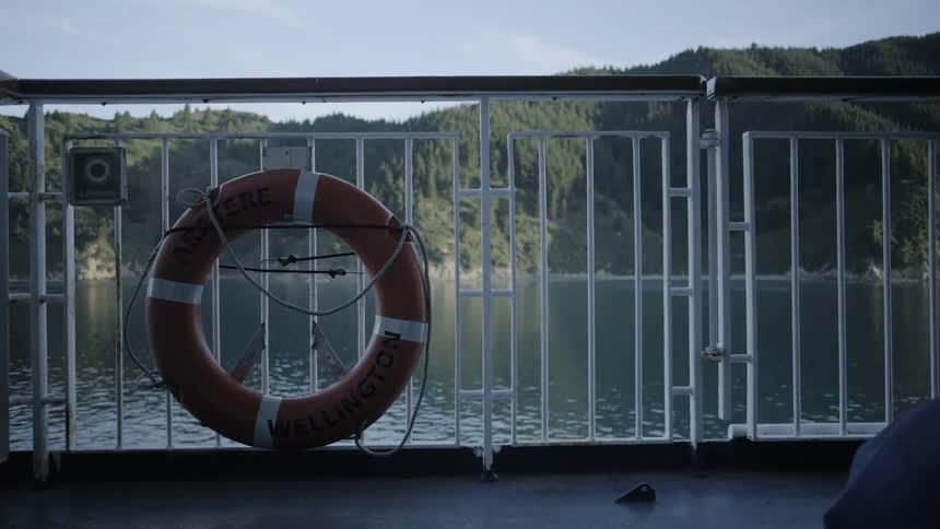 The life preserver is near the side of the boat
