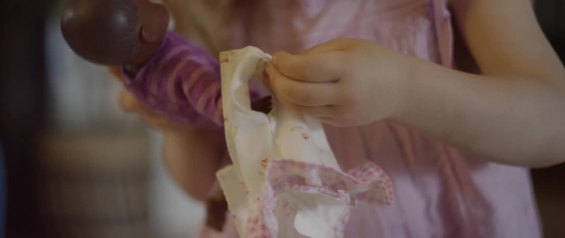 The child is playing with a doll