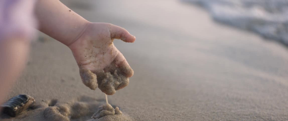 Girl Playing At The Beach