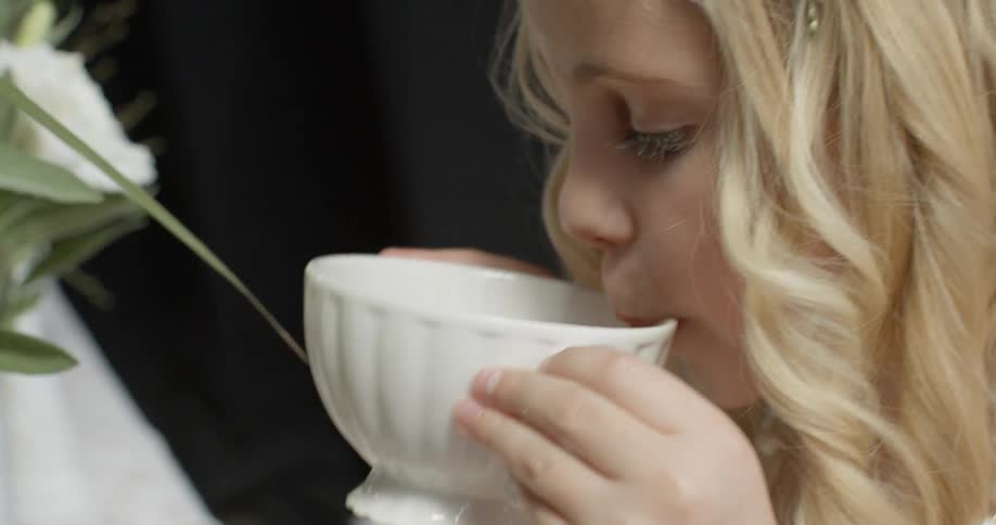 A girl is having a tea party