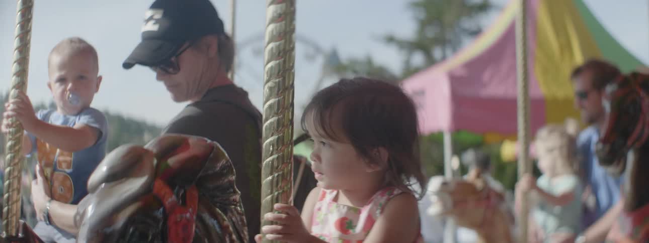 A young girl rides on the carousel