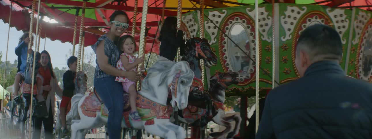 Children and adults ride the carousel at the carnival