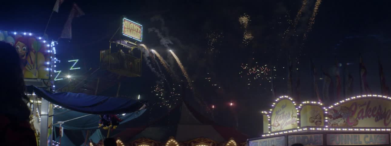 The carnival has fireworks going off in the sky