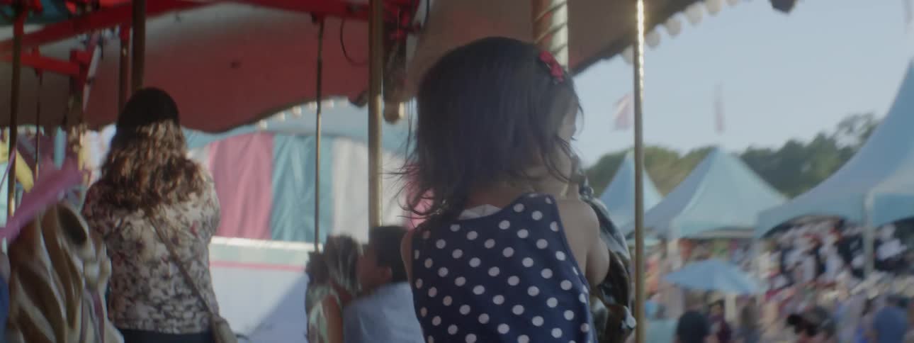Children ride on a carousel at a carnival