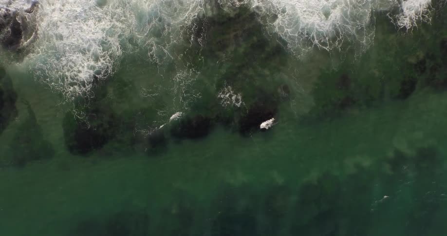 A view of water and waves rushing over rocks