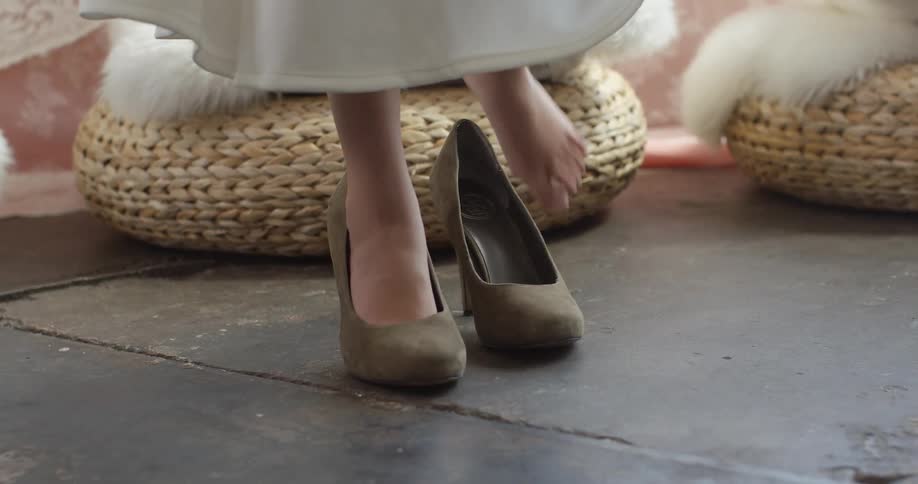 A woman is stepping into her heels