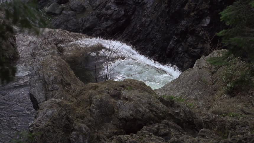 A waterfall gushes over a cliff