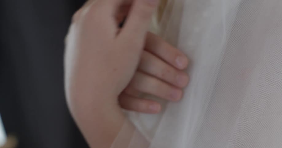 A shirt being touched and tested by a person
