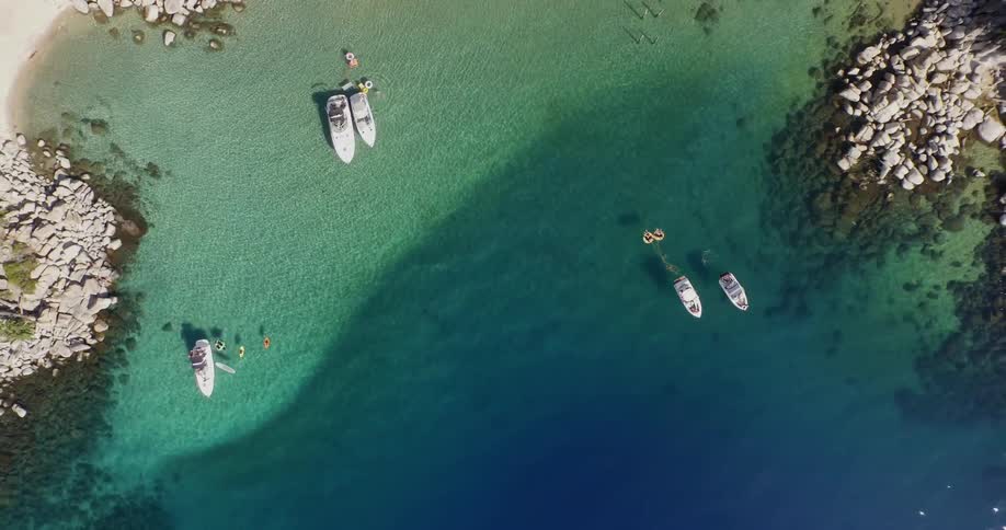 Aerial view of a cost with boats docked in the water