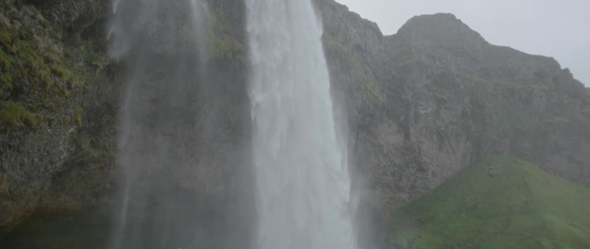 The waterfall covers the area in mist