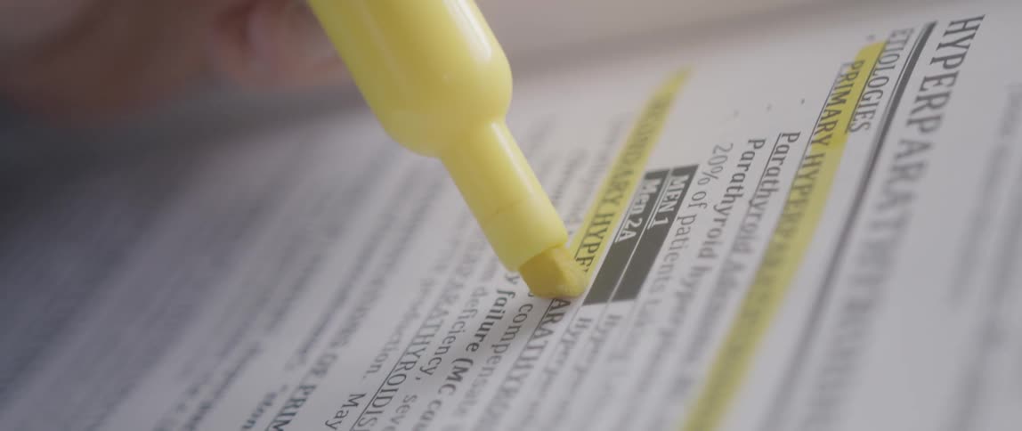 A person is highlighting lines in a book