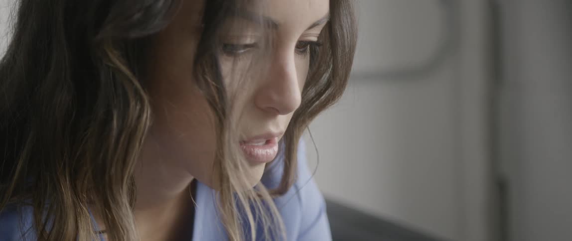 The woman is looking down at something