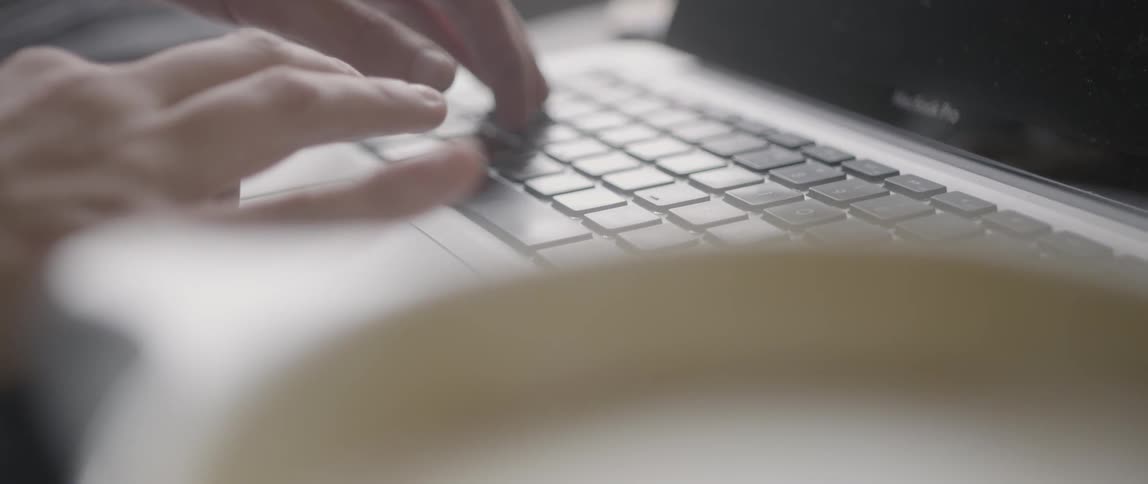 A person uses a macbook laptop