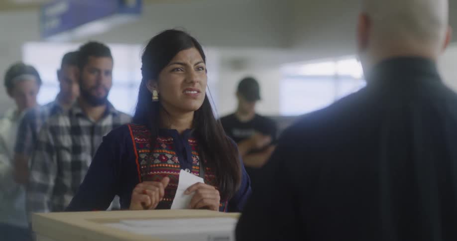 The woman hands over some paperwork to the man