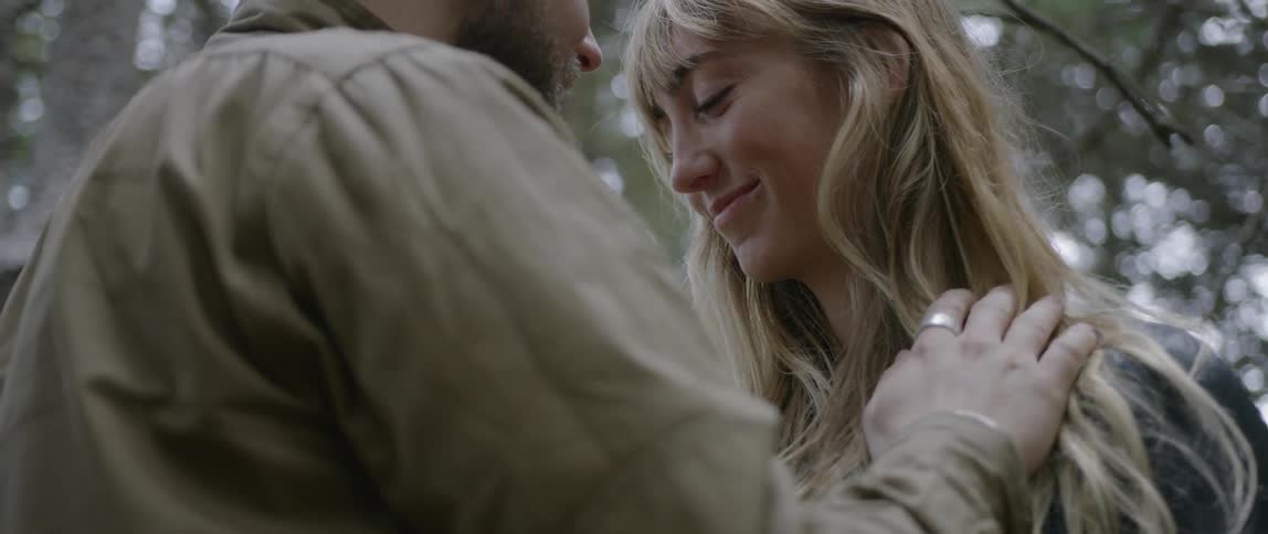 A man and woman gaze into each other's eyes outside